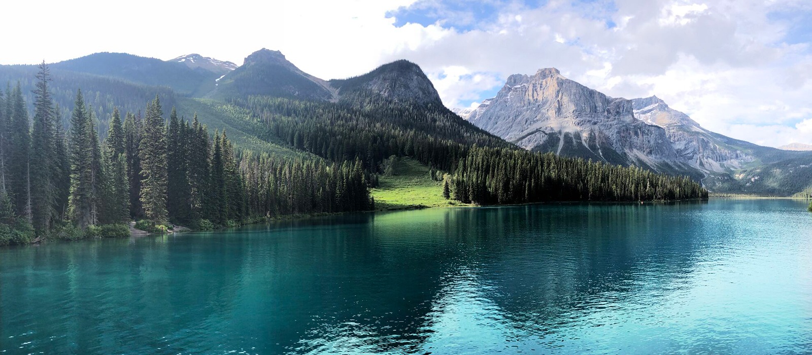 A beautiful scene of a lake with tree and mountain landscape