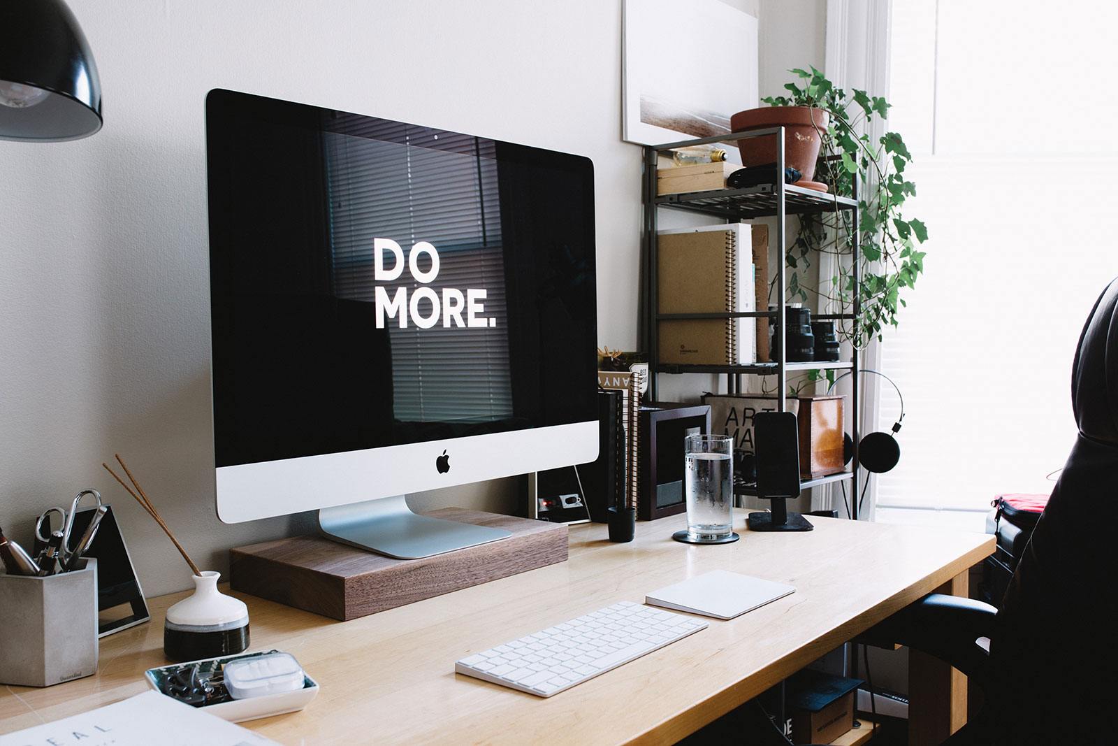 Computer desk with screen saver that says "DO MORE.".