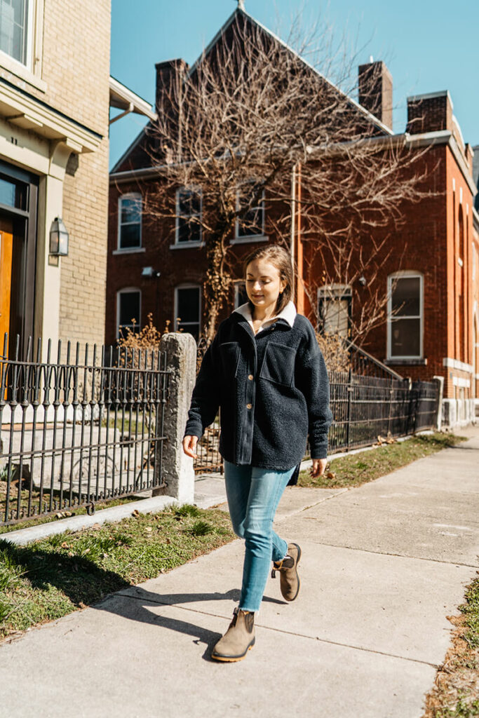 Woman walking on sidewalk