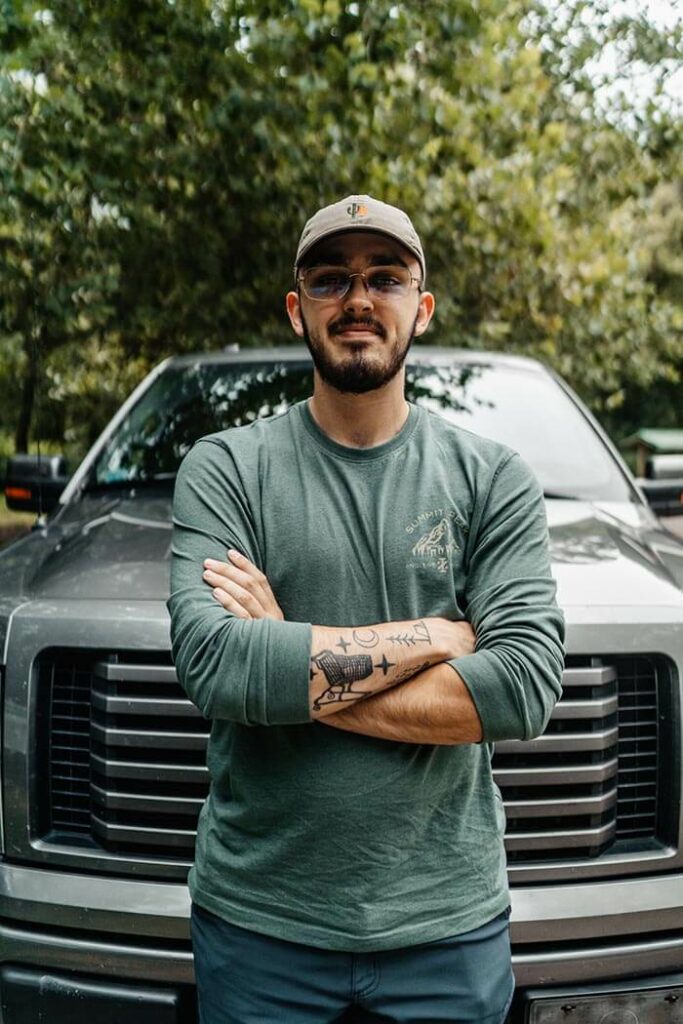 man standing in front of a ford truck