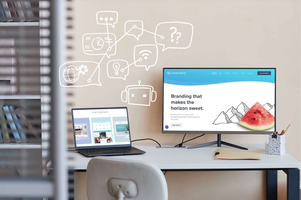 desktop monitor on white desk with laptop and AI chatbot doodles